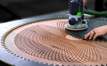 large walnut coffee table with a deep geometric spirograph carving, created using a custom 3D printed router jig and a woodworking router.